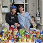 Trent Davis (left) and Michael Mitchell with items they have collected for Dunedin foodbanks....