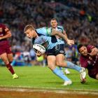 Trent Hodkinson crosses to score for New South Wales against Queensland. (Photo by Mark Nolan...