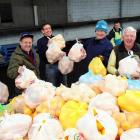 Trevor Croot, Peter Jackson, Les Green, Andrew McKinlay and Les Cleveland load grapefruit and...