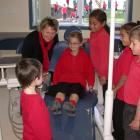Trying out the  clinic  are (from left) Christopher Baird (5), dental therapist Flora McKenzie,...