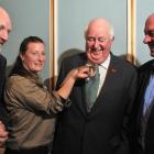 Orokonui ranger Kelly Gough holds a 6-year-old tuatara with (from left) Orokonui Foundation...