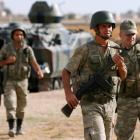 Turkish soldiers guard the Turkish-Syrian border near the Akcakale border crossing, southern...