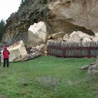 Two tourists stay well clear of a massive rock fall covering the centre portion of the Takiroa...