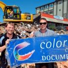 Typesetter Jared Bath (left) stands in the rubble of the Colortronics building yesterday with his...