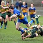 Lewis Kelly of Taieri with the ball is tackled by Mikaire Schooner of Eastern in the under 13...