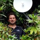 Unifone managing director Travis Baird installs an internet receiver at the offices of the...