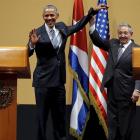 United States President Barack Obama and Cuban President Raul Castro gesture after a news...