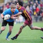 University A flanker Adam Thomson is tackled by Alhambra-Union loose forward Wahari Waitohi in...