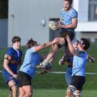 University A loose forward Jack Wolfreys is supported by team-mates Angus Williams (left) and...