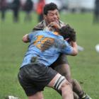 University A replacement Nick O'Connell tries to stop Southern No 8 Mika Mafi during the Cavanagh...