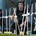 University of Otago design student representative Zac Newton (21) helps arrange crosses that...