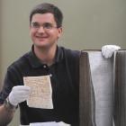 University of Otago doctoral student Daniel Davy examines gold rush-related historical materials...