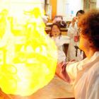 University of Otago PhD chemistry student John Cubanski's flame-covered hand ignites a balloon...