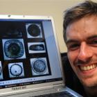 University of Otago PhD student Felix Marx with pictures of diatoms - tiny marine plants which...