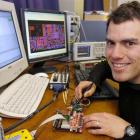 University of Otago student Keith Payne tests the power consumption of a cellphone module for a...