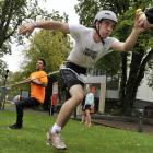 University of Otago student Tom Gilchrist (18) reaches for a drink as competition helper Cameron...