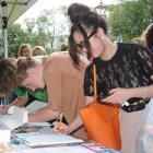 University of Otago students (from right) Anh Hoang and Kimberley Houliston sign a petition...