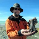 University of Otago zoology department research fellow Dr Nic Rawlence displays a partial femur ...