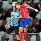 Uruguay's Gaston Pereriro (left) and Serbia's Vukasin Jovanovic compete for the ball during their...