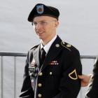 US Army Private First Class Bradley Manning (C) is escorted in handcuffs as he leaves the...
