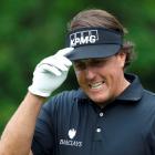 US golfer Phil Mickelson reacts to applause after hitting his tee shot on the 11th hole during...