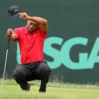 US golfer Tiger Woods wipes his face while on the second green during the final round of the 2013...