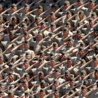 US Marines salute during the national anthem as they attend the MLB game between the New York...