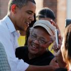 US President Barack Obama hugs a survivor of Hurricane Isaac in LaPlace, Saint John the Baptist...