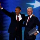 US President Barack Obama (L) joins former president Bill Clinton onstage after Clinton nominated...