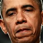 US President Barack Obama pauses while speaking about Friday's deadly shootings in Colorado...