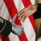 US President Barack Obama shakes the prosthetic hand of Sergeant Leroy Arthur Petry, who received...