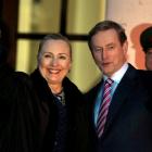 US Secretary of State Hillary Clinton is greeted by Irish Prime Minister Enda Kenny (R) as she...