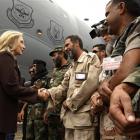US Secretary of State Hillary Rodham Clinton meets Libyan soldiers at the steps of her C-17...