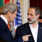 US Secretary of State John Kerry (L) talks with new Syrian National Coalition head Mouaz al...