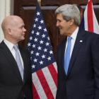 US Secretary of State John Kerry (R) talks with British Foreign Secretary William Hague at...
