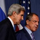 US Secretary of State John Kerry walks next to Russian Foreign Minister Sergey Lavrov (R) before...