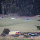 Vehicles (at top) detour through a farm as emergency services attend the scene of the crash....