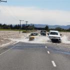Vehicles  negotiate flooding on the Rakahouka-Hedgehope Rd, about 5km south of Hedgehope, where...