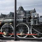 Vickey Miller, of Warrington, uses her hands to cut the reflection while viewing the glass...