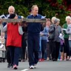 Vise MacKinlay (left) and Gerald Scanlan carry the cross from St Mary's Catholic Parish in...