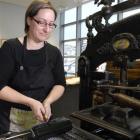Visiting Australian craft printer Caren Florance inks up type on an old Columbian press at the...