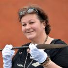 Visiting museum consultant Bridget Wellwood examines a spear, believed to be a relic of the 19th...