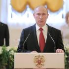 Vladimir Putin (front) speaks during a reception, dedicated to the start of his term as Russia's...