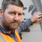 Volunteer Darryl Angus removes graffiti for the Dunedin City Council. Photo by Jonathan Chilton...