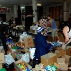 Volunteers at the University of Otago student union work their way through hundreds of donated...