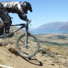 Wade Kenchington, of Queenstown, lines up his path down a sheer section of track