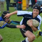 Waihi under-13 player  Lachie Harper  is tackled by Taieri Blue player Jacob Day  during  last...