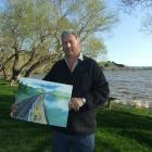 Waihola Looking Forward chairman Stu Michelle holds an artist's impression of the proposed...