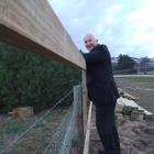 Waitaki Development Board chief executive Mark Jurisich looks at progress on a new fence being...
