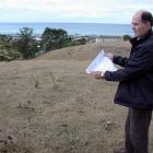 Waitaki District Council property manager Dougall McIntyre with subdivision plans for land above...